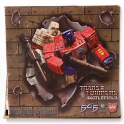 First 4 Figures Transformers Optimus Prime vs. Megatron model, together with a Hasbro Transformers Bumble Bee bust and a Hasbro Transformers Alarm Clock, all boxed