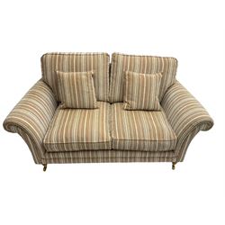 Parker Knoll - 'Burghley' two seat sofa upholstered in pale stripe fabric, raised on turned front supports with brass castors