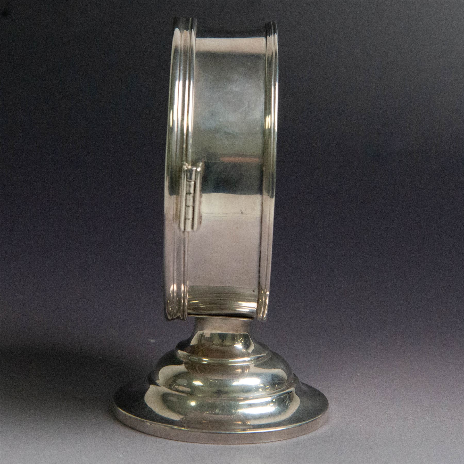 Late Victorian silver lunette, of plain circular form with hinged cover opening to reveal gilt interior, upon a circular domed foot, hallmarked Lambert & Co, London 1897, H13cm