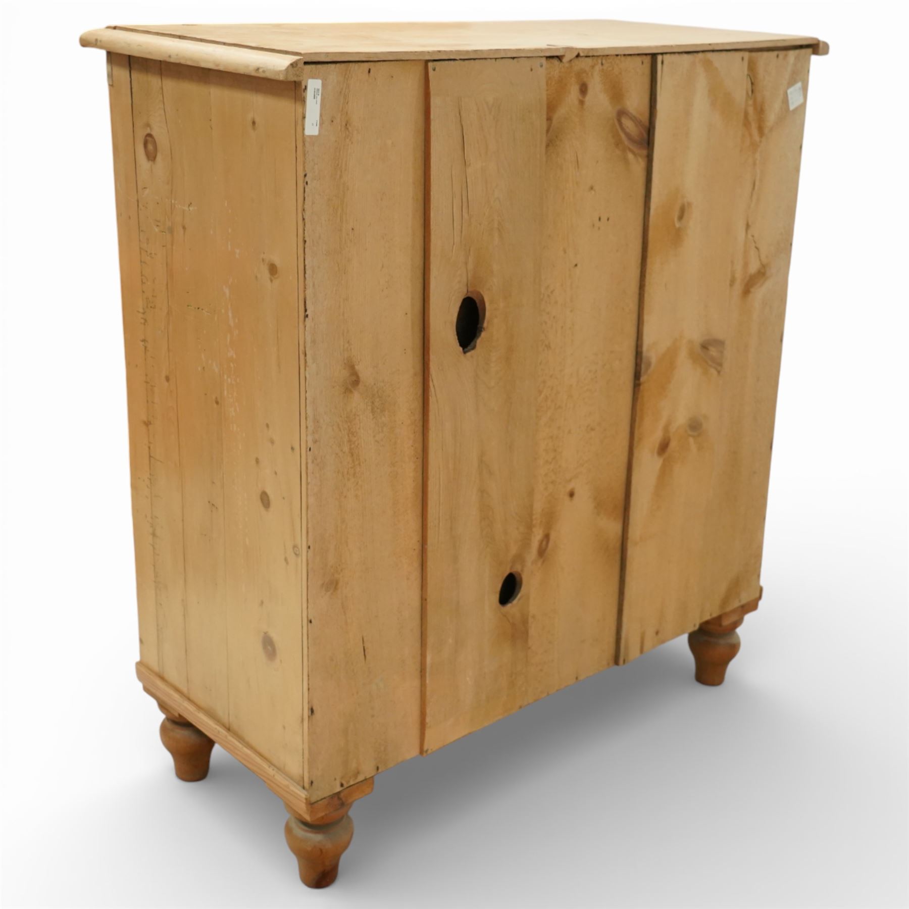 Victorian pine chest of drawers, with rounded top over two short and three long drawers fitted with turned wooden knob handles, raised on turned bun feet