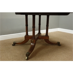 Regency style mahogany breakfast table, rectangular tilt top on four ring turned columns and sabre legs with brass castors, W127cm, D92cm, H68cm  