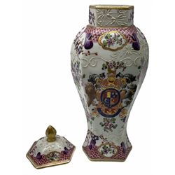 Late 19th century Samson Armorial vase and cover,  of faceted baluster form, decorated in the Compagnie des Indes style with armorial crest and floral sprays, with spurious character mark beneath, H28.5cm