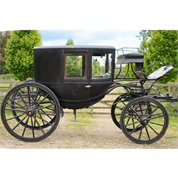 Town Coach by John Marstons Birmingham - Ex Film

A black painted five glass Town Coach by John Marston's Carriage Works Ltd, Birmingham, with enclosed glazed passenger compartment, curved front glass, external coachman's box seat and pole for driving with a pair of horses. The carriage has a timber coach body with buttoned black leather interior, blue upholstered seat cushions, plated exterior door handle, maker plates to the body and step, and John Marston marked hub caps. Mounted on black painted wooden spoked wheels with rubber tyres, leaf spring suspension, underbody turntable steering and iron fittings throughout.
Featured on the film set of 'Victoria' with Jenna Coleman

Features

• Black painted enclosed coach body
• Glazed passenger compartment with five windows
• Curved front glass
• Buttoned black leather interior
• Blue upholstered seat cushions
• External coachman's box seat
• Timber coach body
• Wooden spoked wheels
• Rubber tyres
• Leaf spring suspension
• Underbody turntable steering
• Pole for pair of horses
• Iron foot steps
• Plated exterior door handle
• Maker plates for John Marston's Carriage Works Ltd, Birmingham
• John Marston marked hub caps
• Featured on the film set of Victoria with Jenna Coleman

Dimensions:
Overall length: 390 cm
Width: 190 cm
Height: 214 cm

Wheel Diameters:
Front wheels: 104 cm
Rear wheels: 134 cm

Seating:
Coachman's box: 2
Passenger compartment: 4
