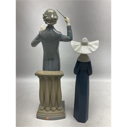 Two Lladro figures, comprising Conductor no 5196 and Prayerful Moment no 5500 together with a Lladro plaque and two Lladro candle holders, Dolphins at Play no 17666 and Sailing the Seas no 17665, all with original boxes, largest example H33cm 