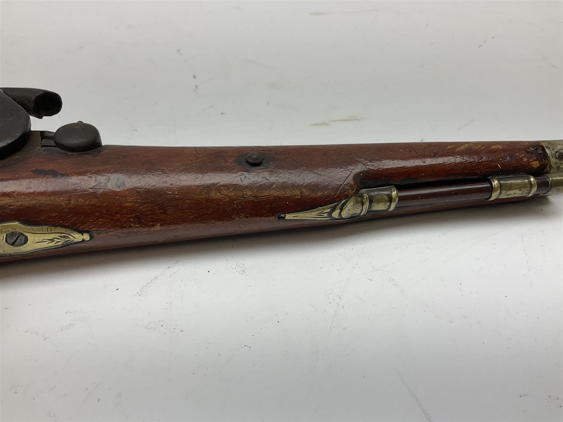 Re-manufactured percussion converted from flintlock single barrel pistol, the 20cm barrel with ramrod under, reused back action lock, brass furniture and hardwood stock L41cm overall