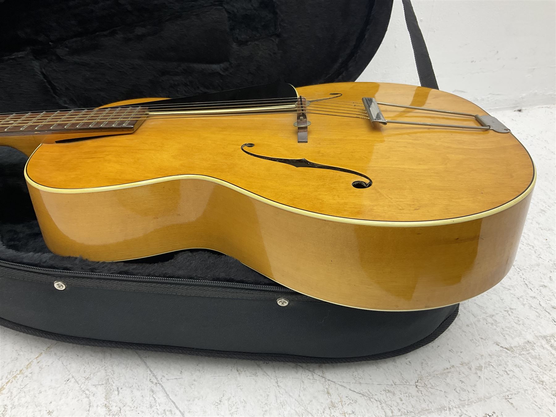 1950s acoustic guitar with f-holes and pickguard L105cm; black fur lined hard carrying case