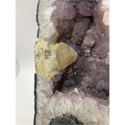 Amethyst crystal ‘cathedral’ geode, free standing with flat base and prepared outer surface, with well-defined crystals of various sizes within the cavern, H39, L32cm