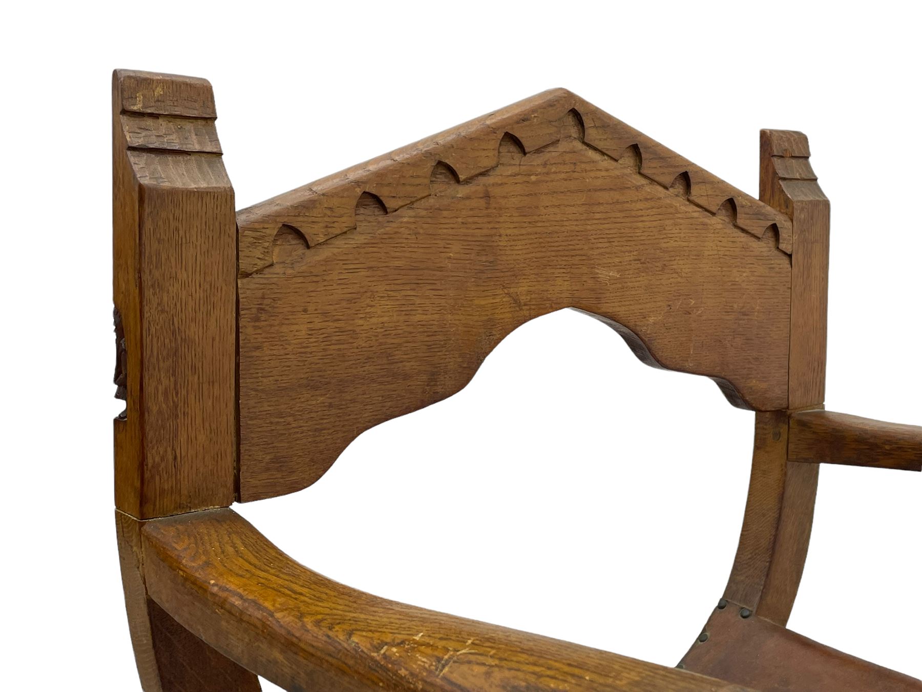 'Gnomeman' oak curved x-framed throne chair, sloped arched cresting rail carved with arcade, studded slung leather seat, the supports joined by sledge feet, rear upright carved with gnome signature, by Thomas Whittaker of Littlebeck