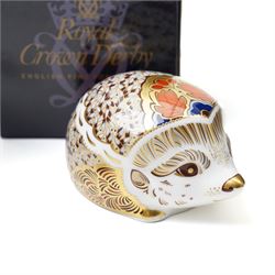 Six Royal Crown Derby paperweights comprising 'Hawthorne' hedgehog with gold stopper, baby rabbit with gold stopper, 'Molly' dog guild exclusive with gold stopper, farmyard hen with gold stopper, woodland squirrel with gold stopper, and collectors guild puppy with gold stopper, all boxed (6)