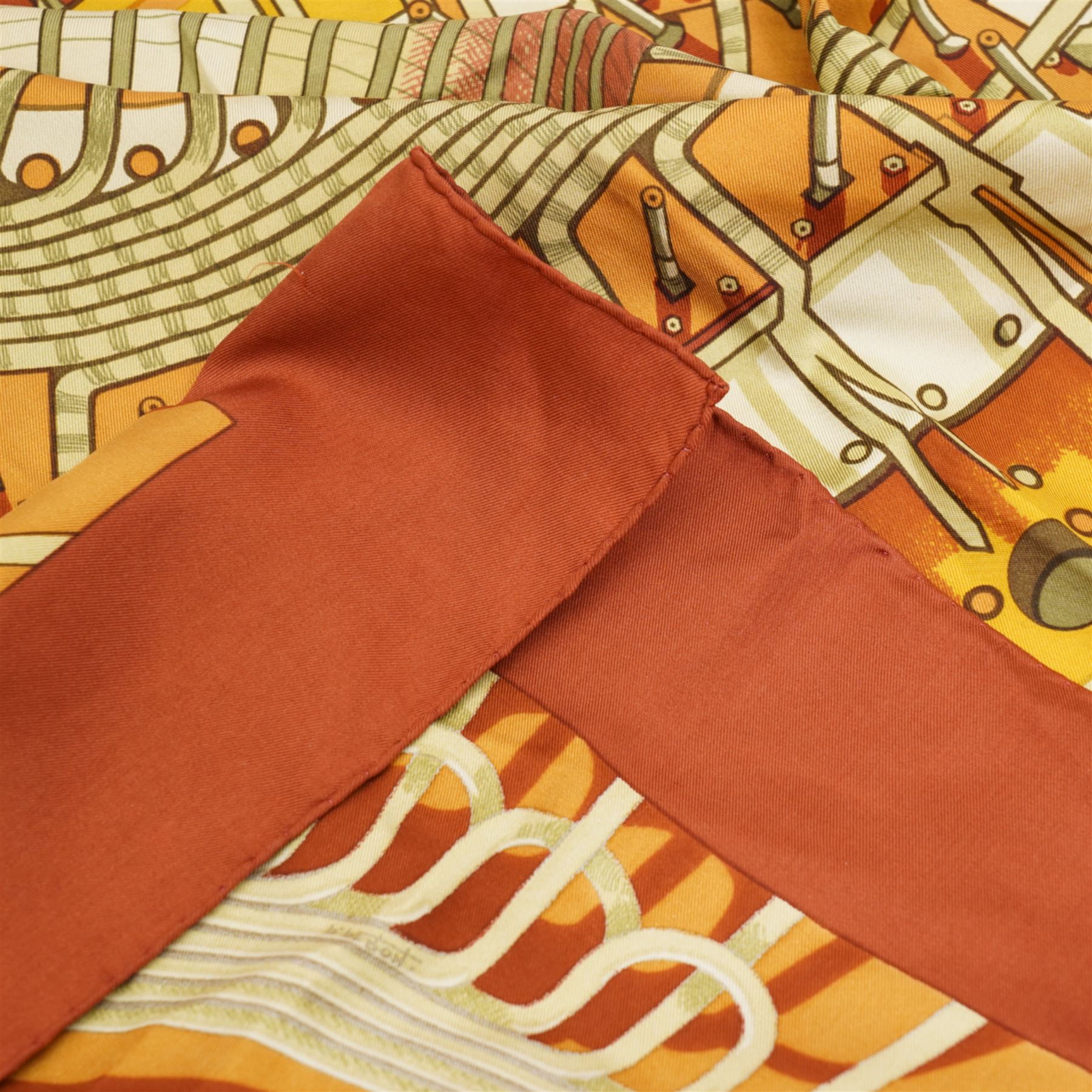 Hermes 'Alternateur' silk scarf in brown and ochre colourway