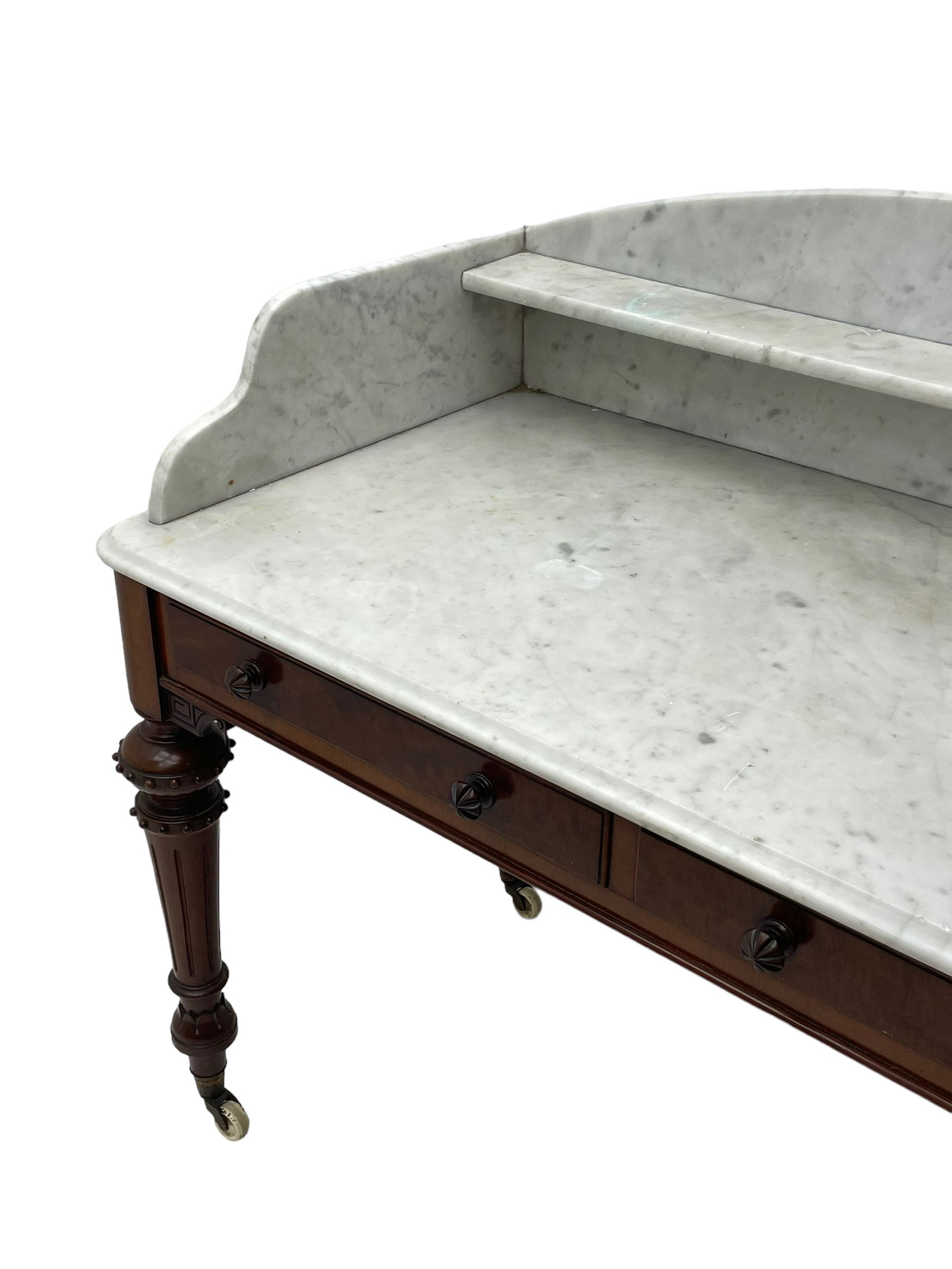 Victorian figured mahogany two-piece bedroom set - the washstand with white and black marble moulded top with arched back and raised shelf, two moulded frieze drawers, on turned and fluted supports with brass and ceramic castors (W123cm, D60cm, H102cm); the dressing table with raised swing mirror in moulded frame with shell and scroll carved pediment, on scrolled horns carved with foliage, four raised trinket drawers over moulded rectangular top, fitted with two drawers, on turned and fluted supports with brass and ceramic castors (W122cm, H177cm, D62cm)
