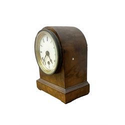 French - late 19th century 8-day walnut table clock, with a round top and shallow plinth raised on block feet, enamel dial with Roman numerals and minute track and decorative pierced steel hands within a gilt slip and cast brass bezel, single train movement with a spring driven going barrel. With pendulum. 