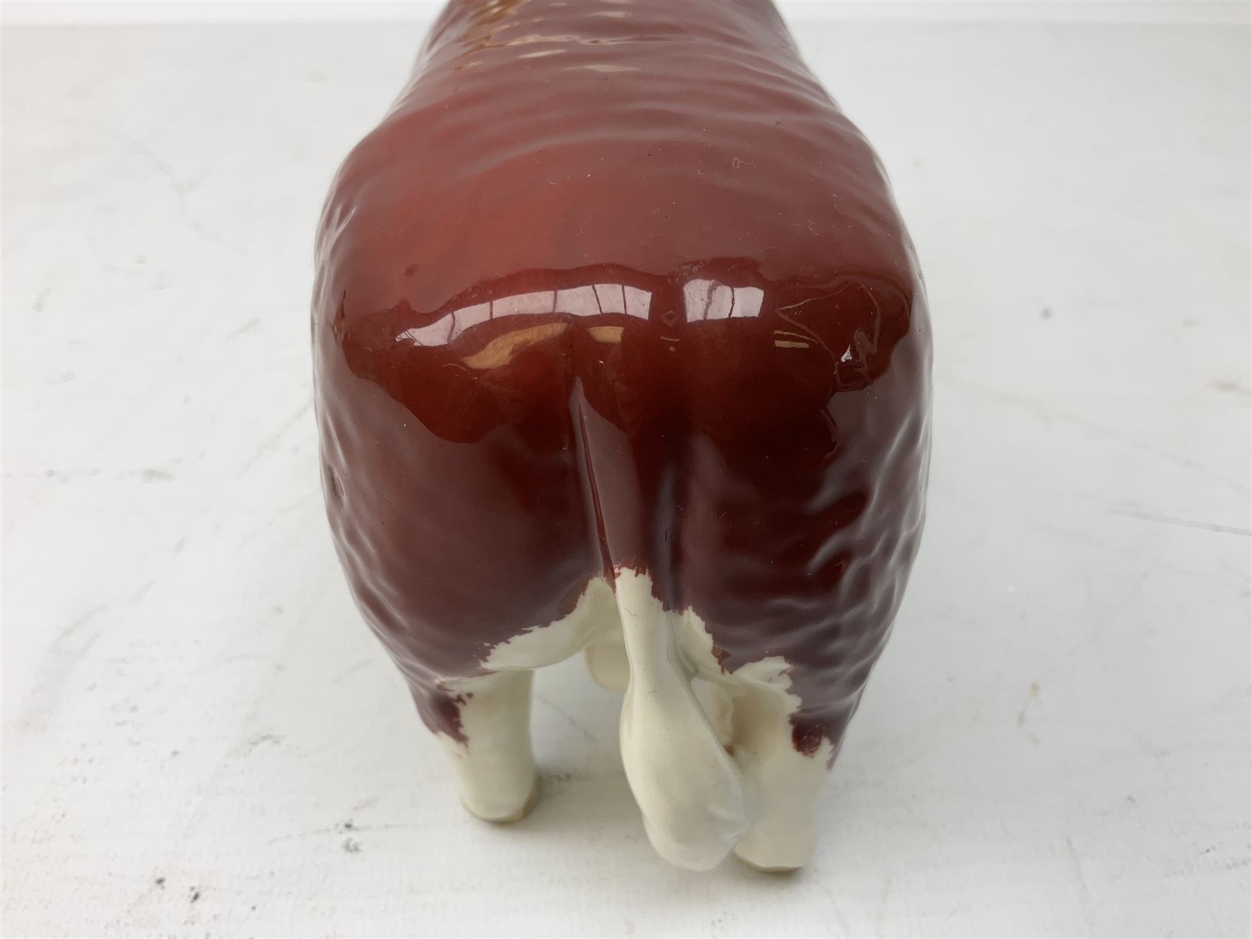 Three Beswick models comprising Hereford Bull no 949, 'CH Cutmil Cupie' Pug, and bay Shire horse, all with printed marks beneath