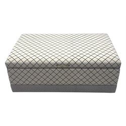 Oka - contemporary mango wood upholstered ottoman, rectangular frame with a printed cotton dhurrie featuring a diamond pattern and wavy stripe border, fitted with brass hinges, decorative studs, and handle