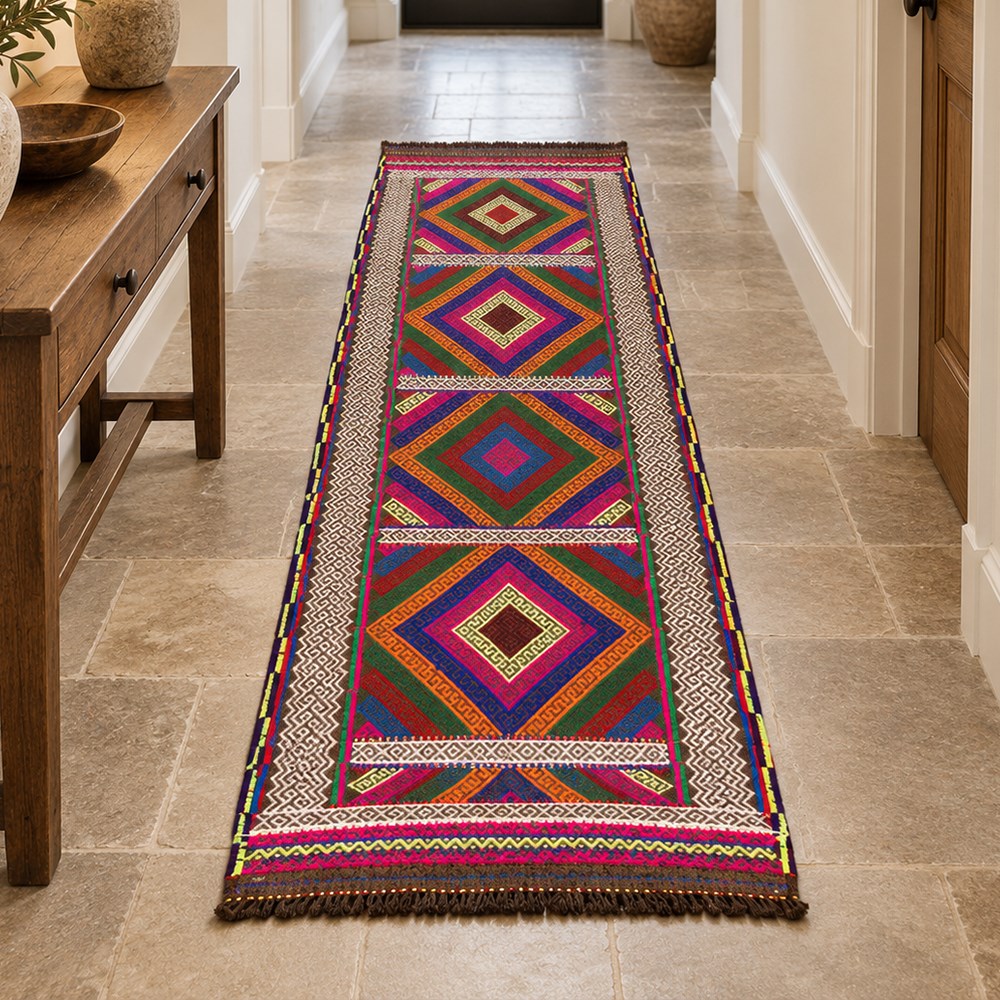Afghan Suzni flatweave geometric design runner rug, decorated with trailing lozenges decorated with hooked motifs, within zig-zag bands, bright multi-coloured ground ivory and brown geometric main border