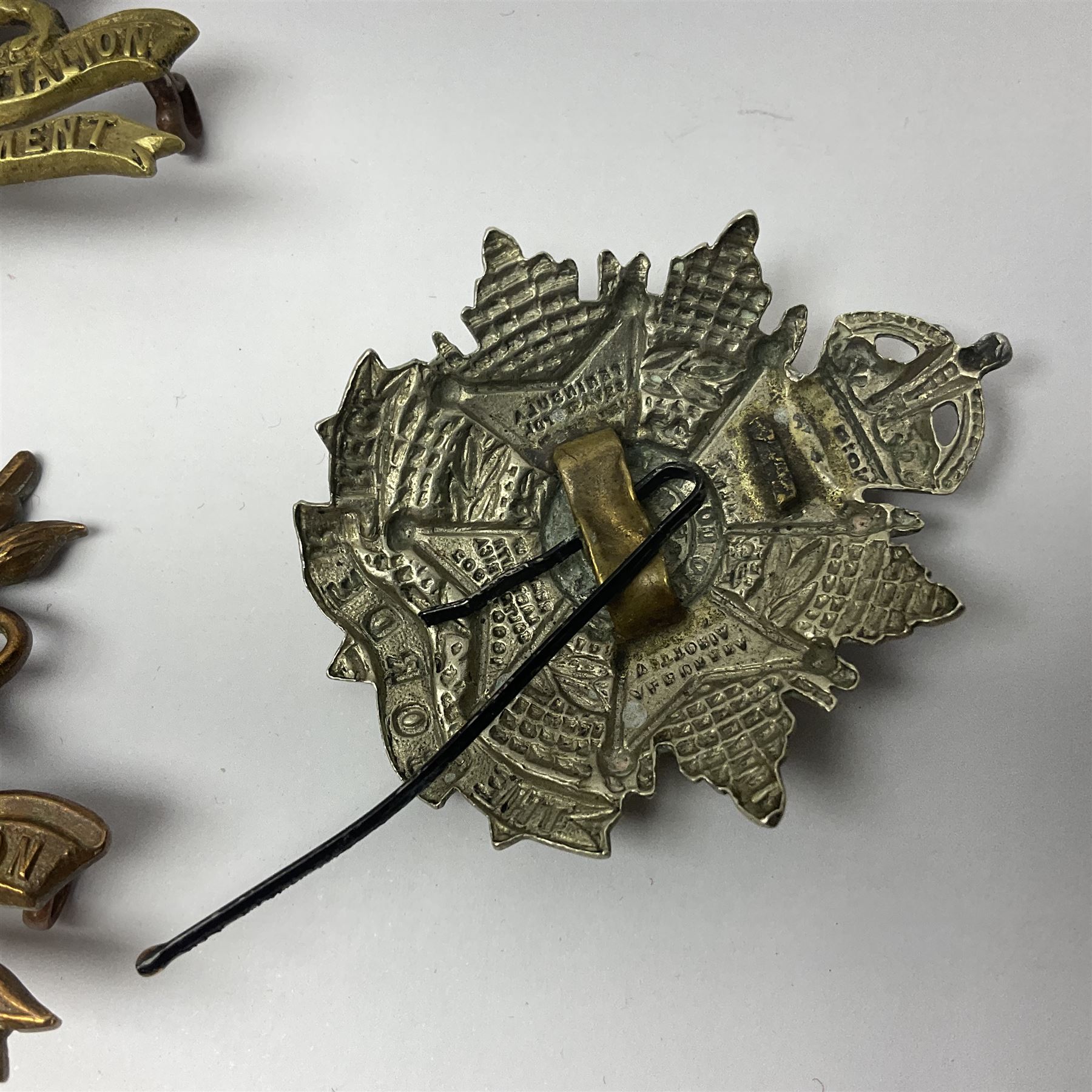 Four Border Regiment cap badges including eleventh battalion (4)