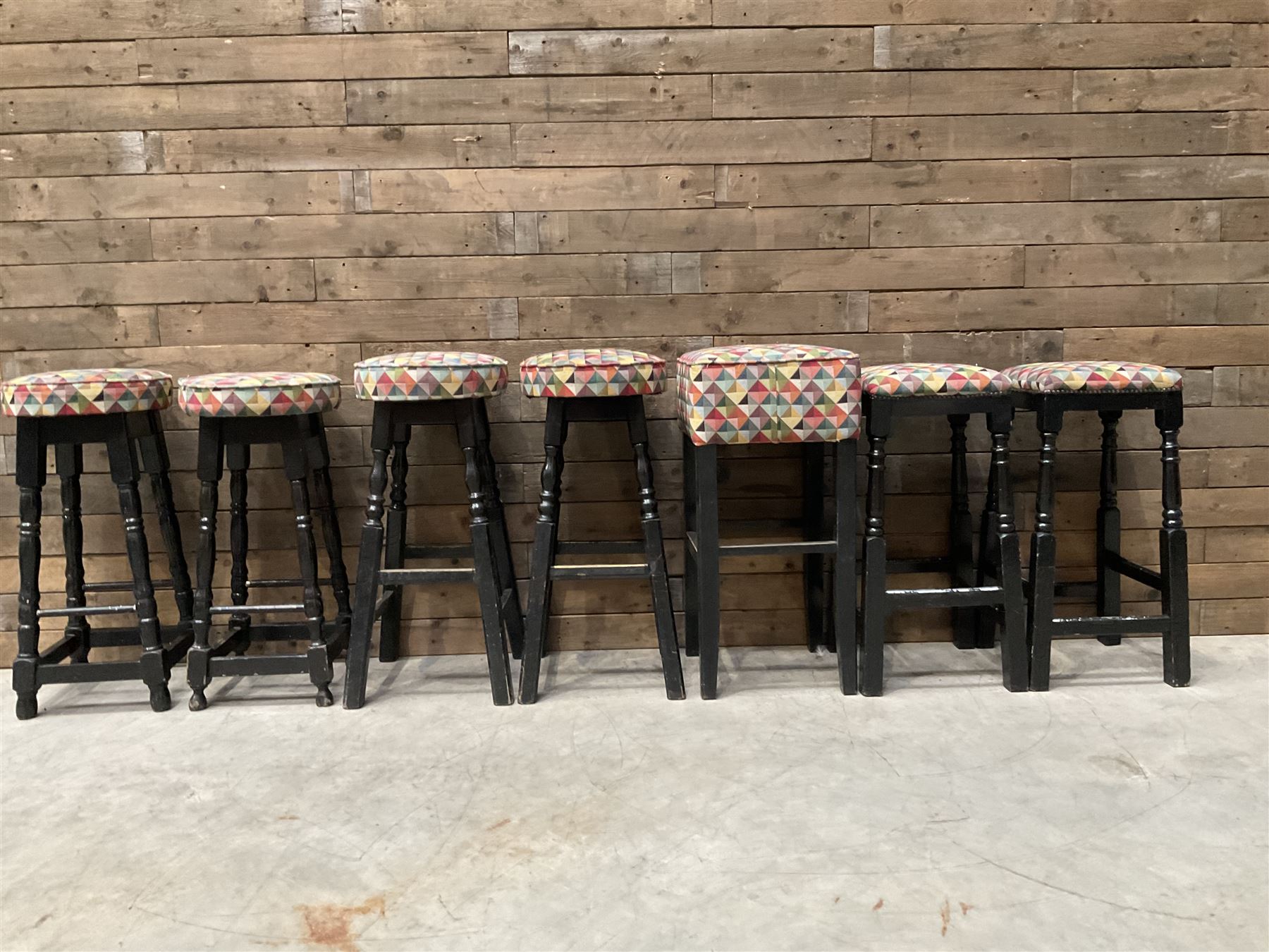 Seven tall bar stools with upholstered seat