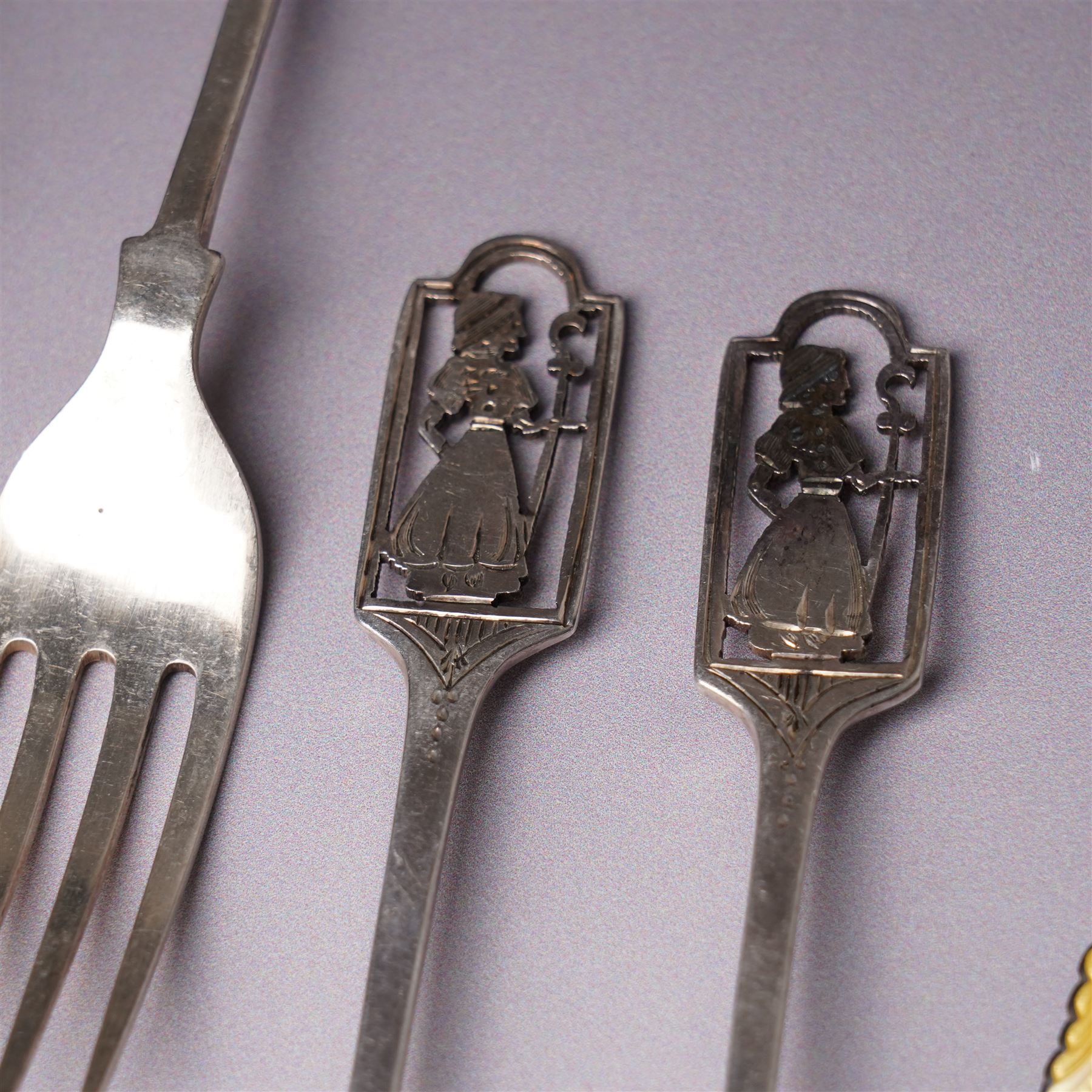 Small silver photograph frame,  four decorative silver forks, two silver and enamel spoons, other silver spoons and silver cased fob watch 