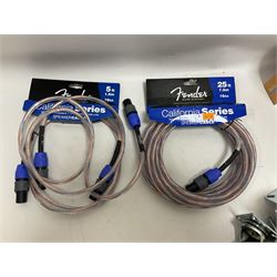 Guitar accessories, to include three Truetone 1 Spot Combo Packs, three Fender California Series speaker cables, including 25ft example, Stagg speaker cables, other cables, mainly Fender, two Fender guitar straps and two sets of amp wheels