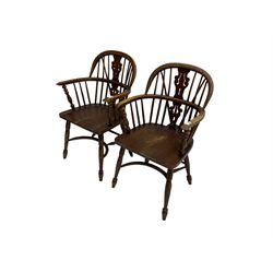 Pair late 20th century oak Windsor elbow chairs, double hoop and stick back with pierced and fretwork work splat, dished seat on turned supports joined by crinoline stretcher