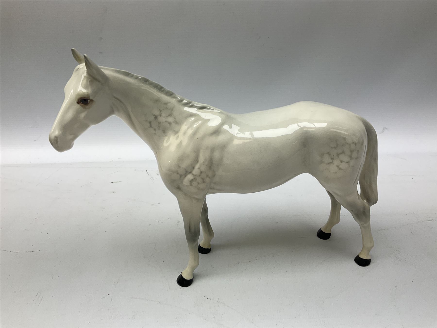 Collection of Beswick horses, including grey horse no.701, palomino foal no 836, grey stocky jogging mare no.855 etc, together two Royal Doulton horses, (8)
