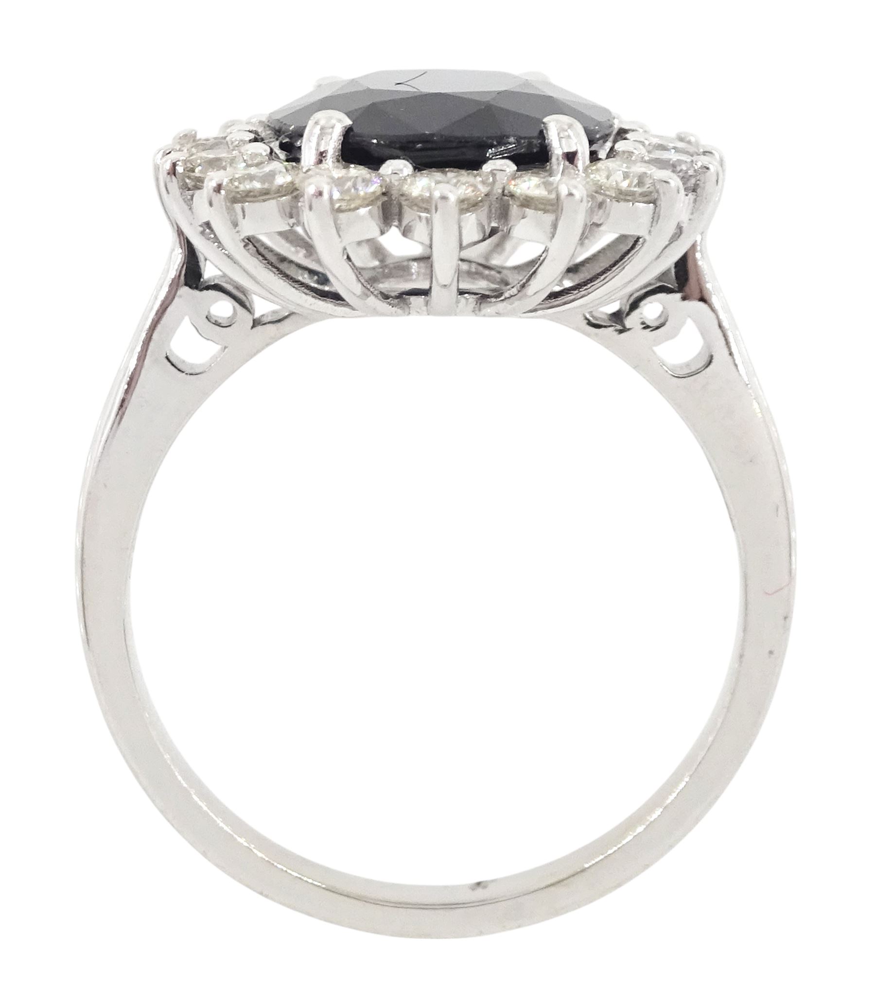 18ct white gold sapphire and diamond cluster ring, single oval cut sapphire of 4.33 carat, with round brilliant cut diamond surround, stamped 750, total diamond weight 0.72 carat