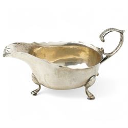 George III silver cream jug with gadrooned edge and leaf capped handle on shaped supports London 1817 Maker Robert Peppin and a small Victorian silver sauce boat with crimped rim Birmingham 1893 Maker Thomas Hayes (2)