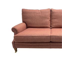 Edwardian design grande two-seat sofa, upholstered in wool herringbone rouge fabric, rolled arms, on square tapering supports with brass castors