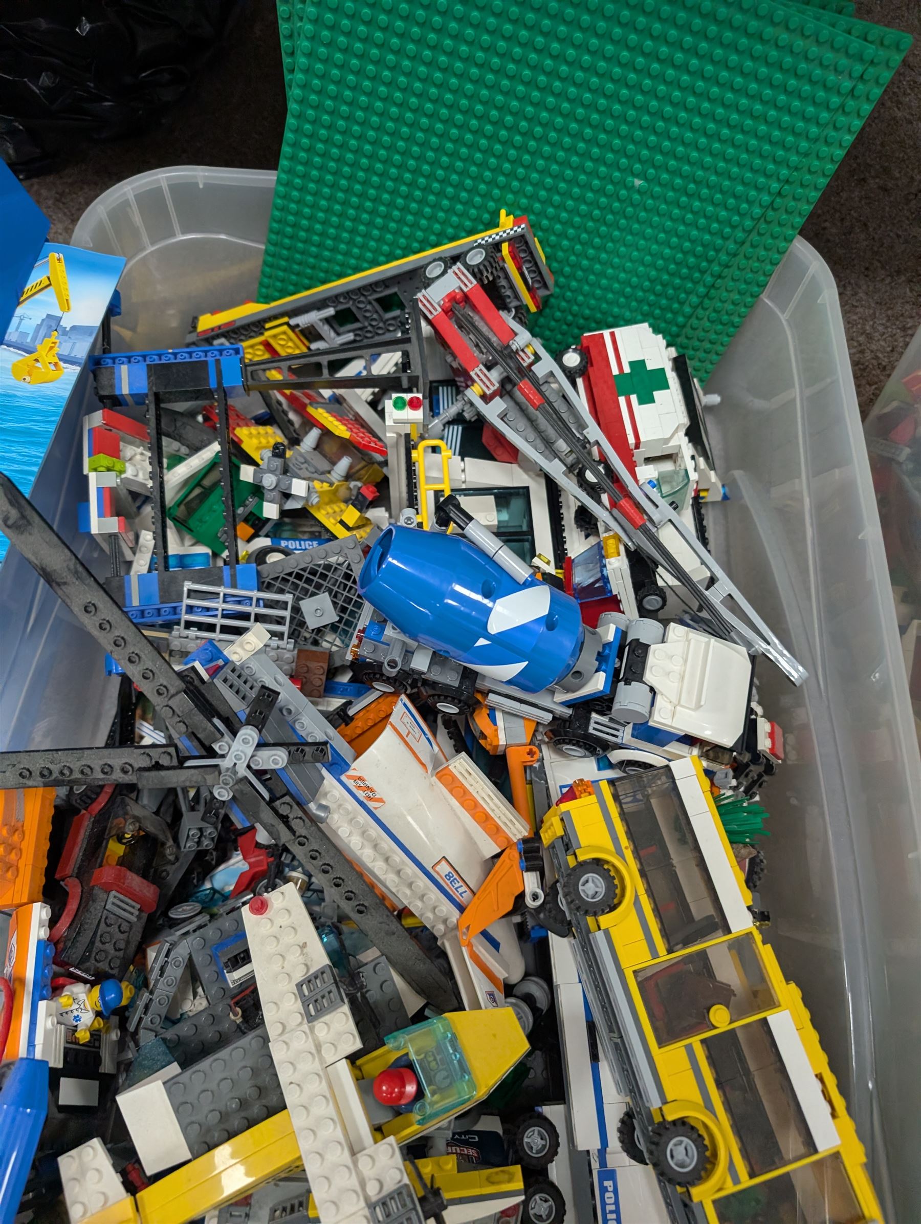 Large collection of Lego, including partially built vehicles, Police Station, Lego Creator 31010 and a collection of Lego instruction booklets