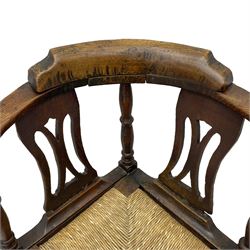18th century country elm and oak corner chair, the shaped cresting rail terminating to swept arm resets, supported by turned columns and pierced shaped splats, over a drop-in rush seat, raised on square supports united by box stretcher