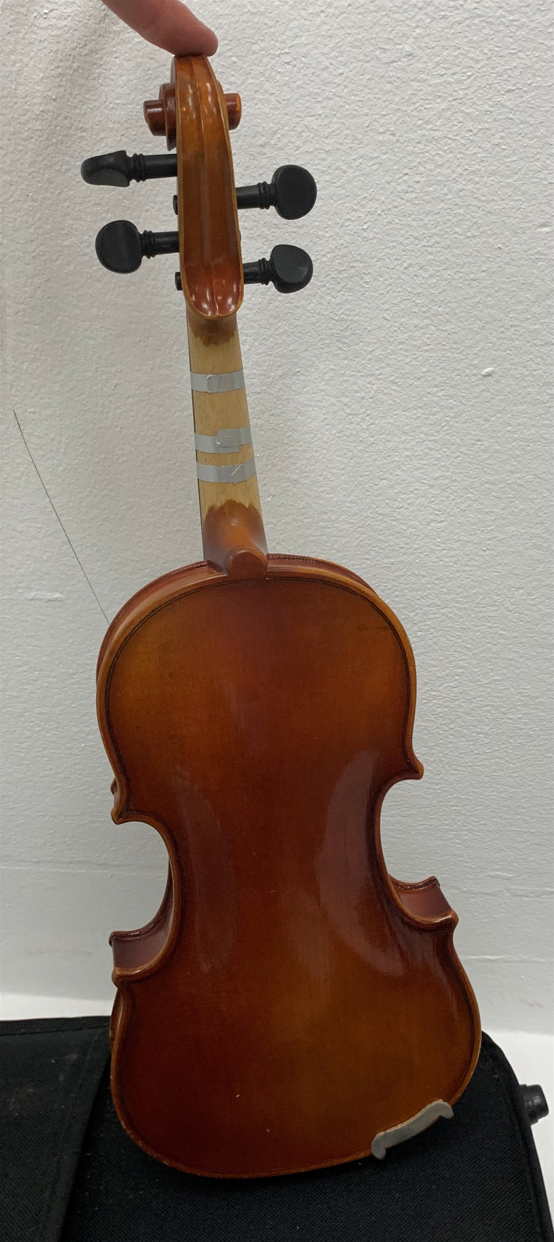 Three modern graduated violins - Suzuki 1/10 size child's violin with 23.5cm single piece back, bears label serial no.94282, 40cm overall; copy of Antonius Sradivarius of Cremona violin dated 1998 with 28cm two-piece back, 47cm overall; and Strobel violin with 35.5cm two-piece back, bears label dated 2006, serial no.512801325, 59cm overall. All cased with bows (3)