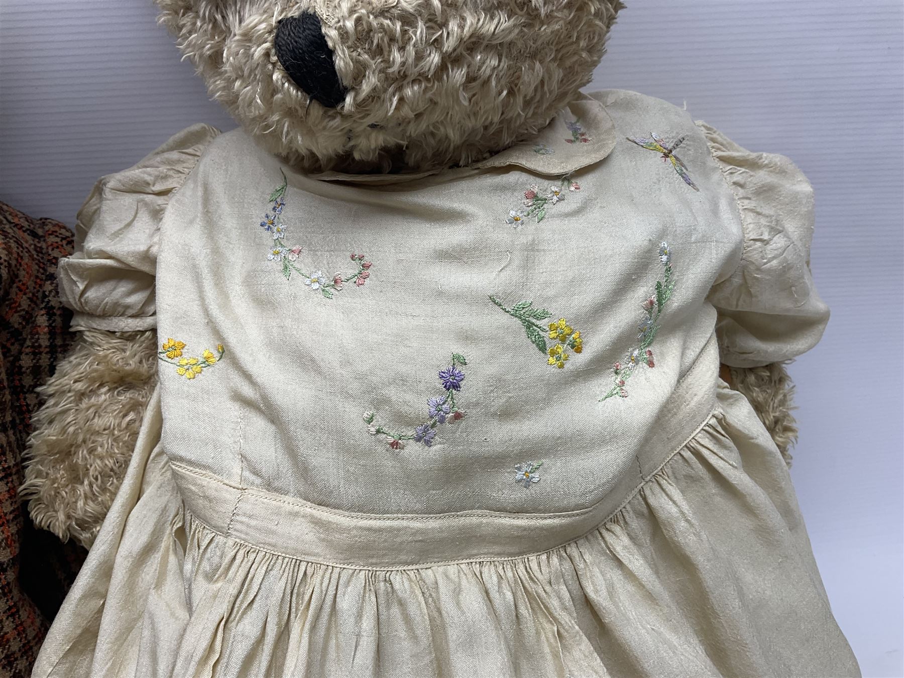 Two early 20th century straw filled jointed teddy bears, first example wearing a tweed jacket bearing Geoffrey Saville label, with leather padded paws and ears, horizontally stitched nose and humpback; second example with applied eyes, vertically stitched nose and faux leather paw pads, both with growler mechanisms, tallest H74cm 