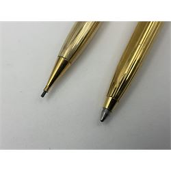 Sheaffer Triumph Imperial fountain pen, the gold plated barrel with fluted stripe design and gold nib stamped 14K 585, together with a Sheaffer Targa slimline fountain pen with gold plated barrel similarly decorated with gold nib stamped 14K 585, ballpoint pen and propelling pencil, each with a fluted gold plated barrel, largest L13.5cm (4)