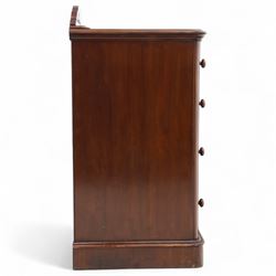 Pair of tall Victorian mahogany bedside chests, of narrow upright form, rectangular top with moulded edge, the back with raised pierced fretwork gallery, above four graduated drawers with knob handles, raised on a plinth base 