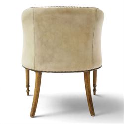 Early 20th century Georgian design mahogany framed desk or club armchair of tub form, with turned pilaster arm supports and legs with rear splayed supports, upholstered in faded tanned leather with loose seat cushion
