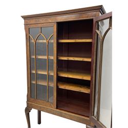 19th century figured mahogany bookcase, projecting dentil cornice over figured frieze, two astragal glazed doors enclosing four adjustable shelves, on acanthus carved cabriole supports with ball and claw feet