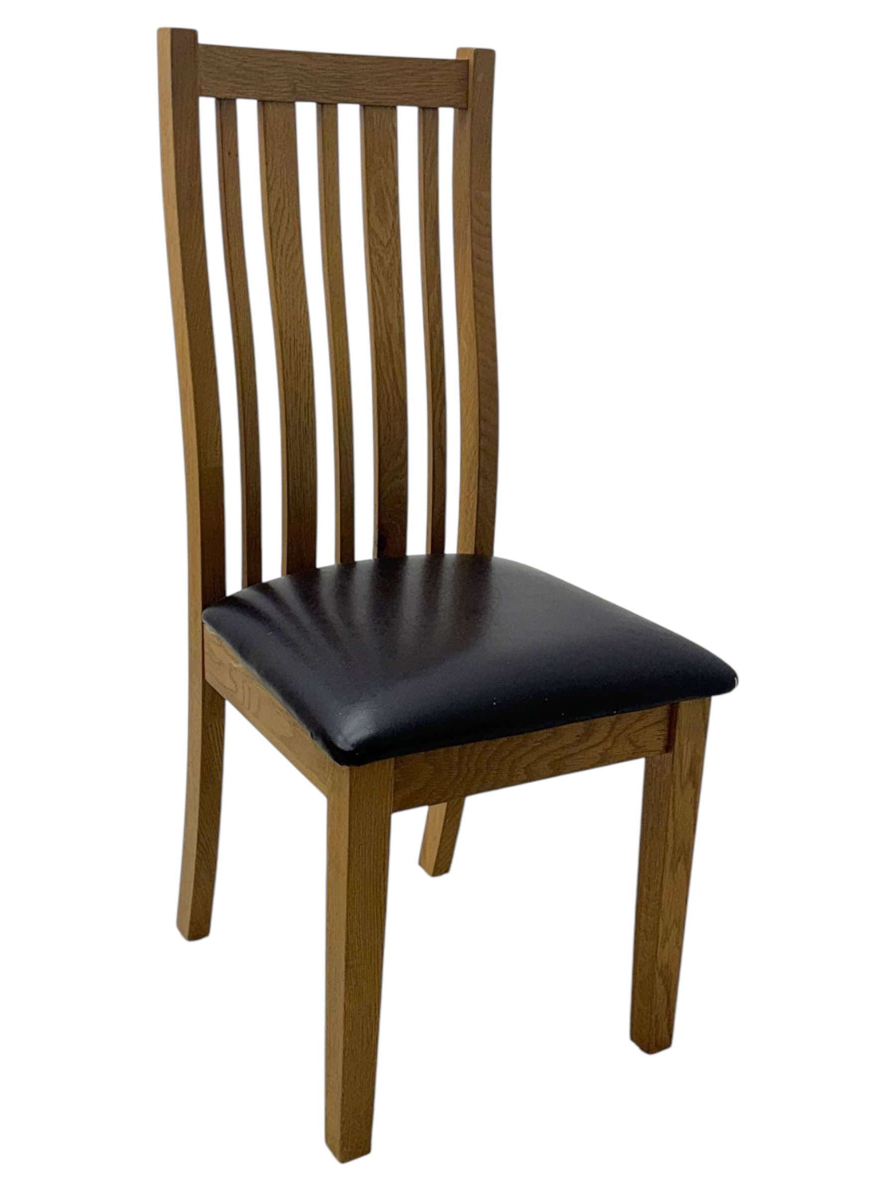 Light oak extending dining table, with four chairs, breadboard ends with integrated fold out leaf with latches, on square supports, tall slatted backrest with brown leather drop in seat  

(Extended 165cm)