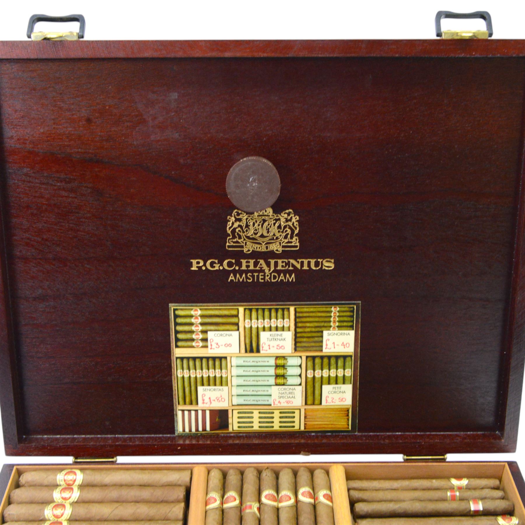 P.G.C. Hajenius of Amsterdam mahogany humidor, containing various loose Hajenius cigars, including Corona, Corona Naturel Special, Klieine Tuitnak, with matches and cigar cutter, D30cm, L38cm   