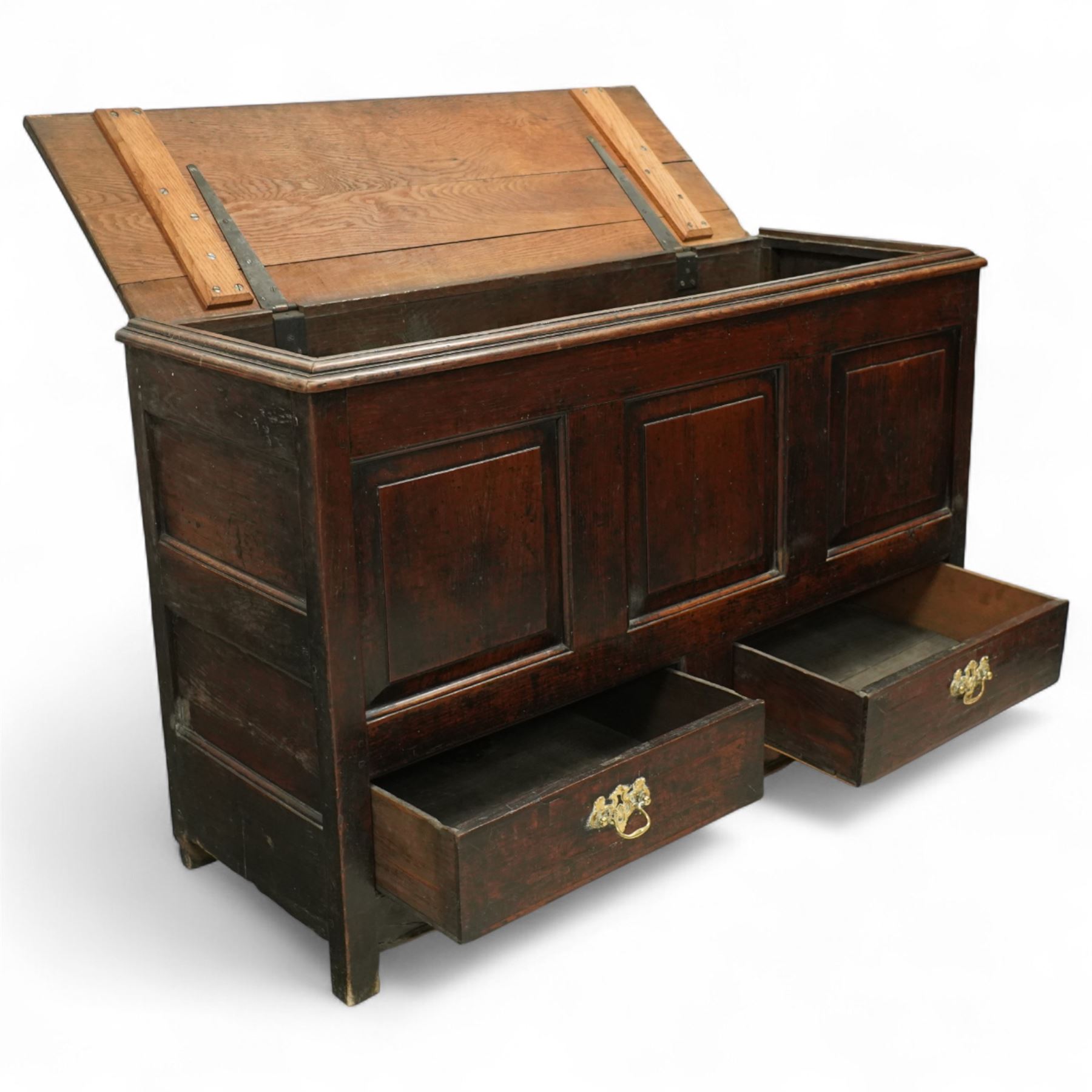 19th century oak coffer, the hinged plank top above a panelled front fitted with two drawers to base, raised on bracket feet