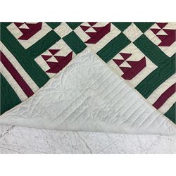 20th century quilt, with repetitive ship design to the centre within a cream red and green boarder, 227cm x 222cm