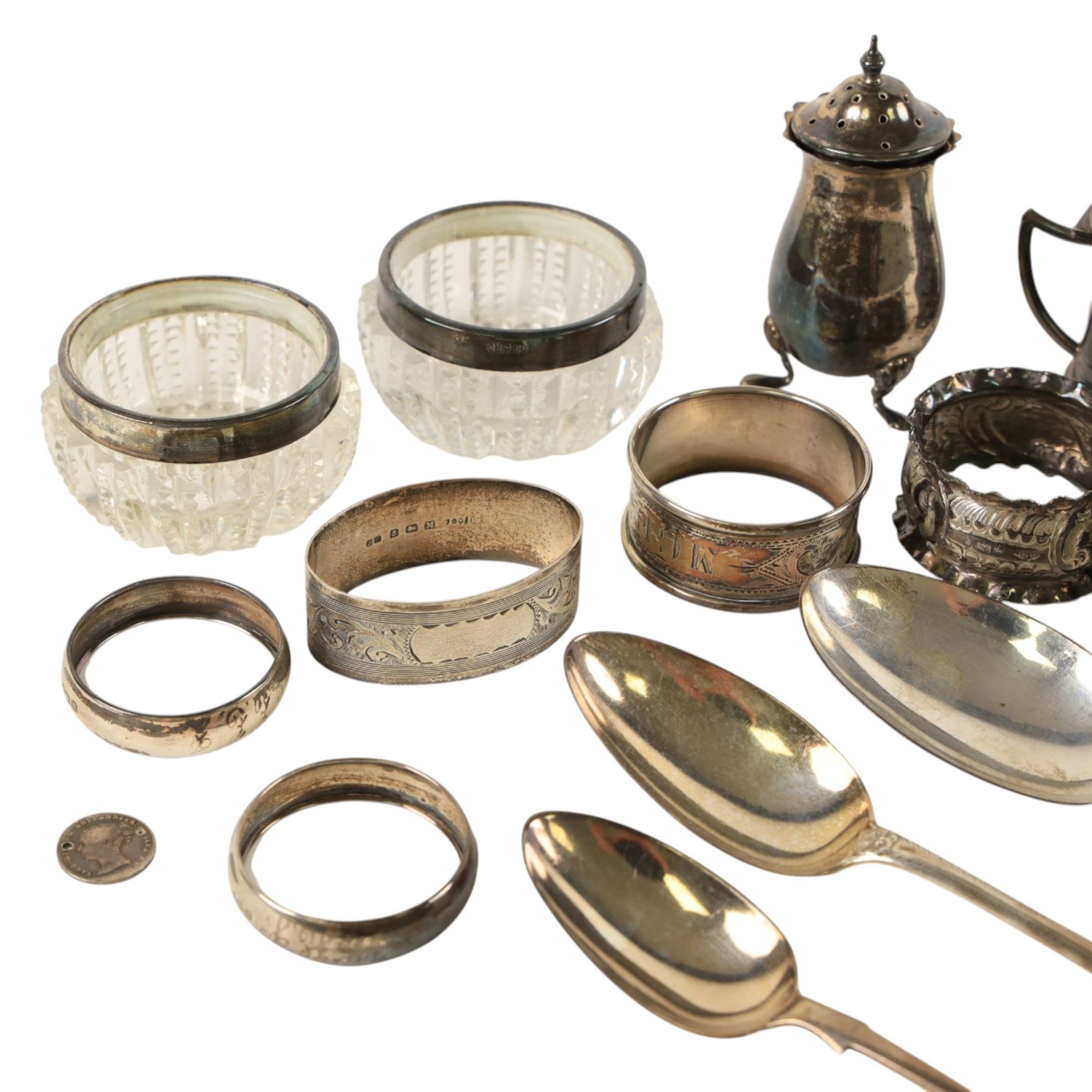 Collection of silver, including pepper shaker, mustard pot, three spoons, two silver collared glass salts and six napkin rings, all hallmarked 