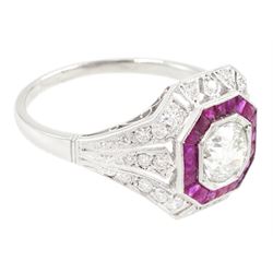 Platinum diamond and ruby cluster ring, the principal transitional cut diamond of approx 0.65 carat, in an octagonal milgrain setting, surrounded by calibre cut rubies, to further round brilliant cut diamonds and a split design shoulders