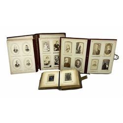 Three Victorian musical albums including one leather bound smaller example all with brass fixtures and interior gilt decoration bordering the apertures of portraits of various sizes and shapes, with boxed cylindrical movements