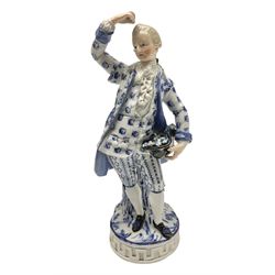 Meissen blue and white figure of a gentleman, modelled stood holding his black at full of flowers in one hand, and raising a flower above his head in the other, raised upon Greek key design base, with blue crossed swords and impressed C 73 and 149 marks beneath, H18cm