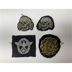 Collection of eleven German metal and cloth badges and uniform buttons including driver's badge, two 'SS' fabric skulls, private's shoulder tabs, Police cloth badge, tank destruction badge, medal bars and ribbon etc; most WW2 period