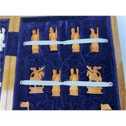 Chinese resin chess set, complete with character pieces housed in a folding case, the exterior decorated as a board, L40cm
