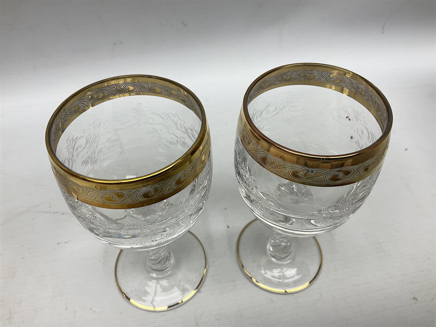Set of twelve Moser style wine glasses, the bowls with etched floral bodies and gold banded rim with foliate decoration raised upon stem of twisted form, H14cm