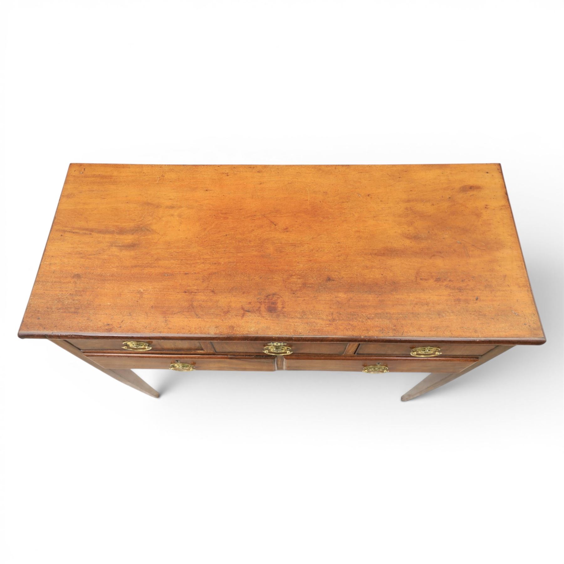 Georgian mahogany side table fitted with drawers, rectangular top over five drawers with brass handles, raised on tapering square supports