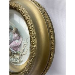 Set of four early 20th century Continental bisque plaques, each of circular form, modelled in high relief as the Four Seasons personified, within gilded circular frames under convex glass, overall D44.5cm