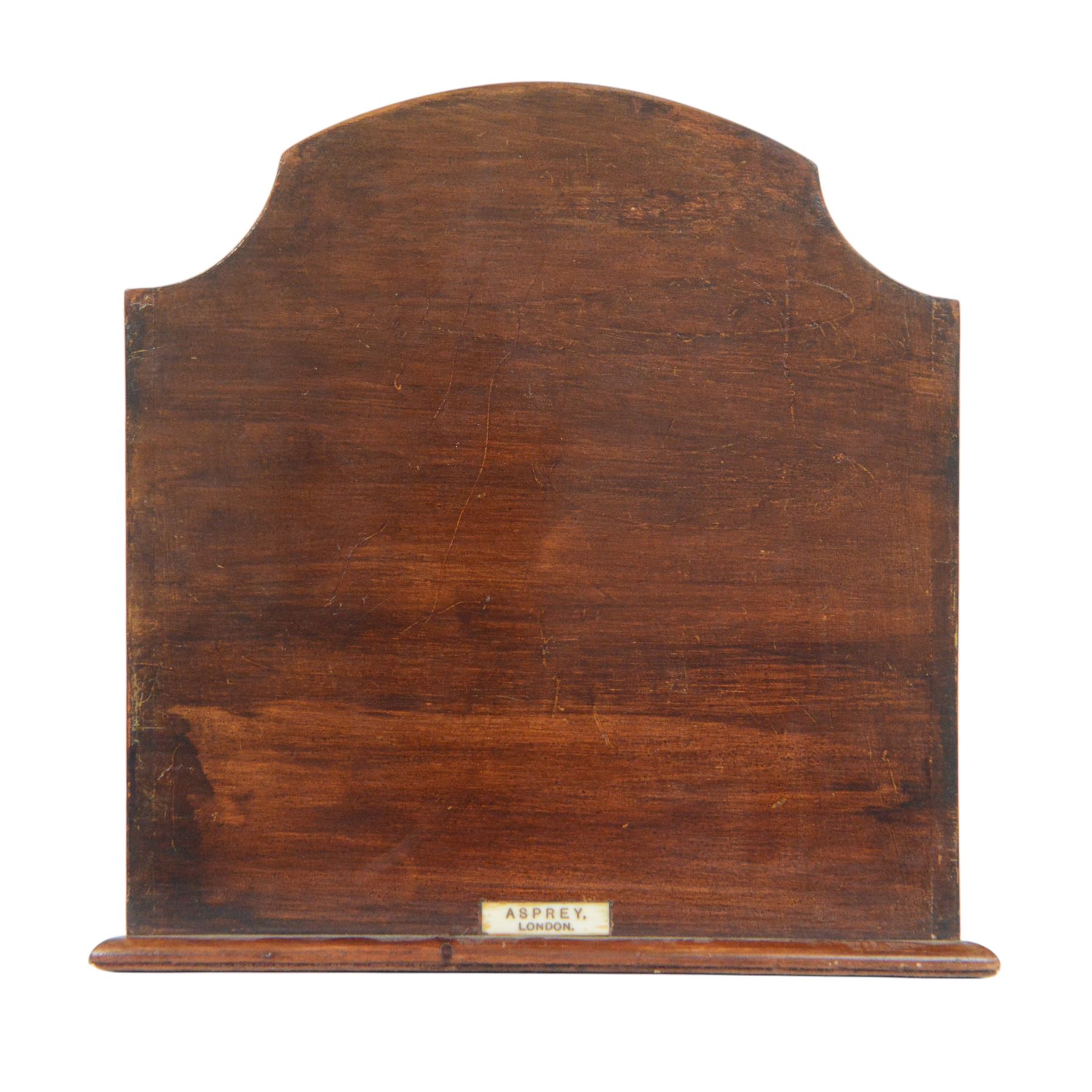 Edwardian Asprey mahogany desktop book trough, the segmental arched back with inlaid fan patera and serpentine shaped sides, above single recess and moulded base rail, housing Asprey & Co Ltd leather bound reference library, comprising Dictionary, French and English Dictionary, English Quotations and Proverbs, Classics and Mythology, Encyclopedia, French and Latin Quotations, Gazetteer, and Atlas, book trough, 22cm x 22.5cm x 11cm
